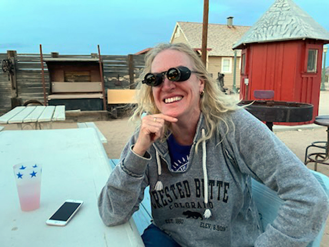 Laura Misajet at Checking out the grill with a little help from a camel. Camp with the Camels at Goffs, Mojave Desert Heritage & Cultural Association photo: Bill Slutter